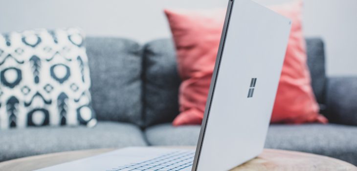 macbook pro on white couch