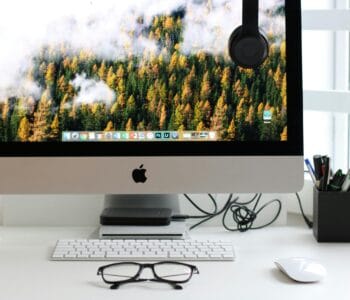 Free Stylish home office workspace featuring a computer setup with accessories. Stock Photo