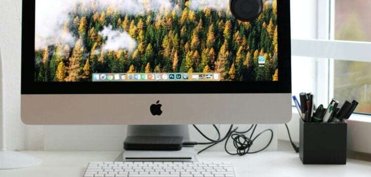 Free Stylish home office workspace featuring a computer setup with accessories. Stock Photo