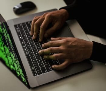crop-cyber-spy-hacking-system-while-typing-on-laptop