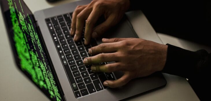 crop-cyber-spy-hacking-system-while-typing-on-laptop