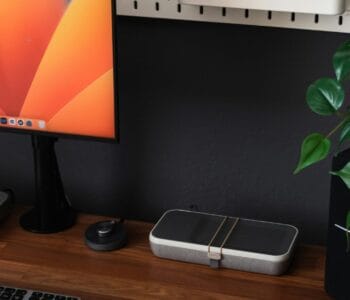 a desk with a laptop, keyboard, mouse and a monitor
