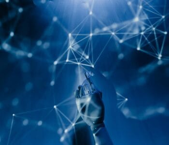 Free A robotic hand reaching into a digital network on a blue background, symbolizing AI technology. Stock Photo