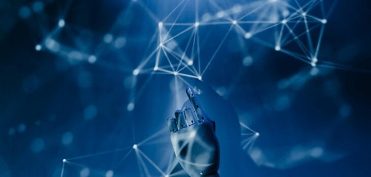 Free A robotic hand reaching into a digital network on a blue background, symbolizing AI technology. Stock Photo