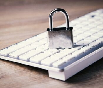 a computer keyboard with a padlock on top of it