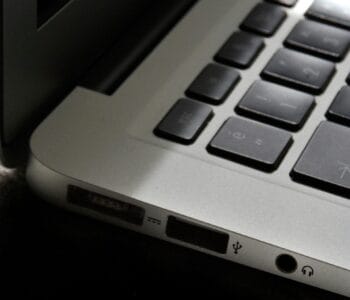 Free Detailed view of a silver laptop showing keyboard and multiple ports. Stock Photo
