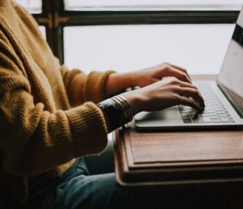 person sitting front of laptop