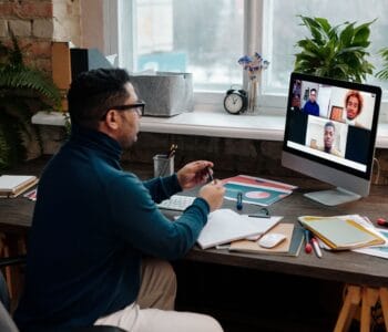 teacher-video-calling-with-his-students-using-a-computer