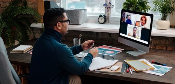 teacher-video-calling-with-his-students-using-a-computer